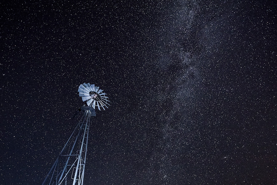 A Nebraska landscape scenic photograph of a windmill under a night sky with lots of stars. - Nebraska Photography