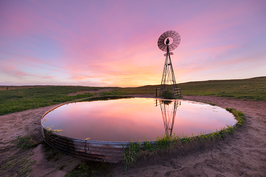 A photograph of a windmill in the Nebraska Sandhills during a summer sunset. - Nebraska Photography