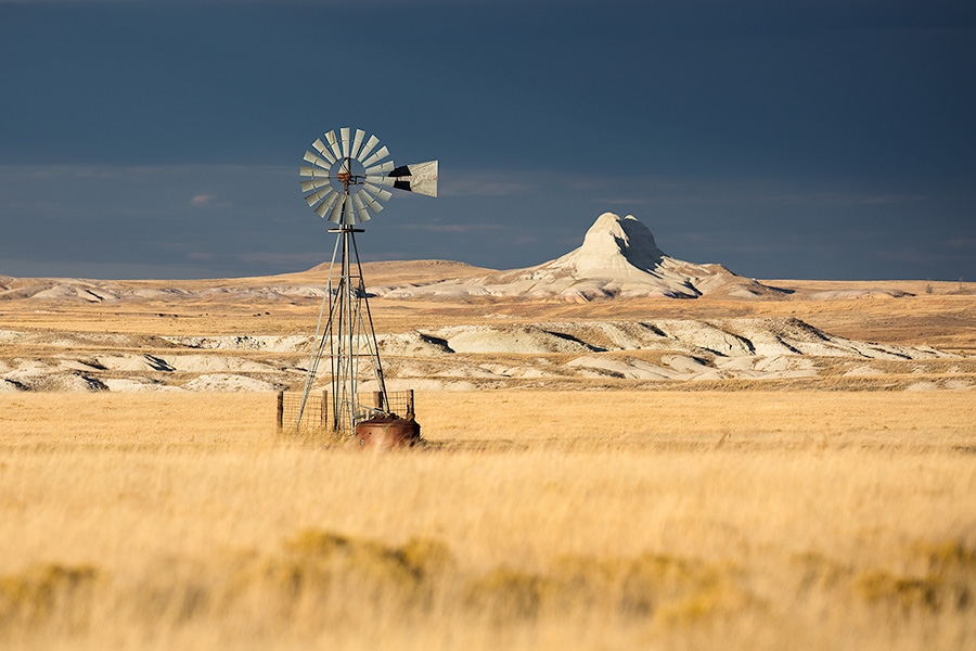 Scenic landscape panoramic photograph of a windmill and Sugarloaf Butte at Oglala National Grasslands. - Nebraska Photography