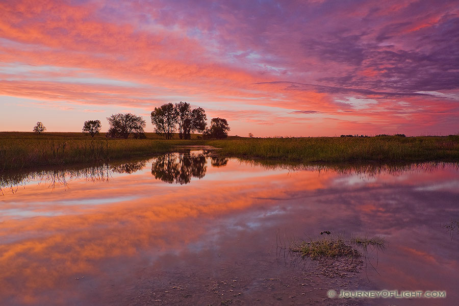 A beautiful sunset reflects off a saltwater marsh in eastern Nebraska near Lincoln. - Nebraska Photography