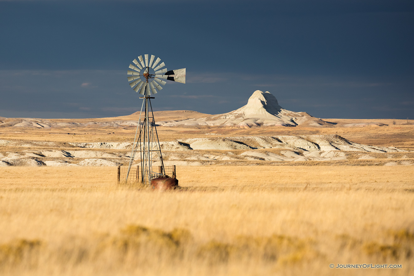 Scenic landscape panoramic photograph of a windmill and Sugarloaf Butte at Oglala National Grasslands. - Nebraska Picture